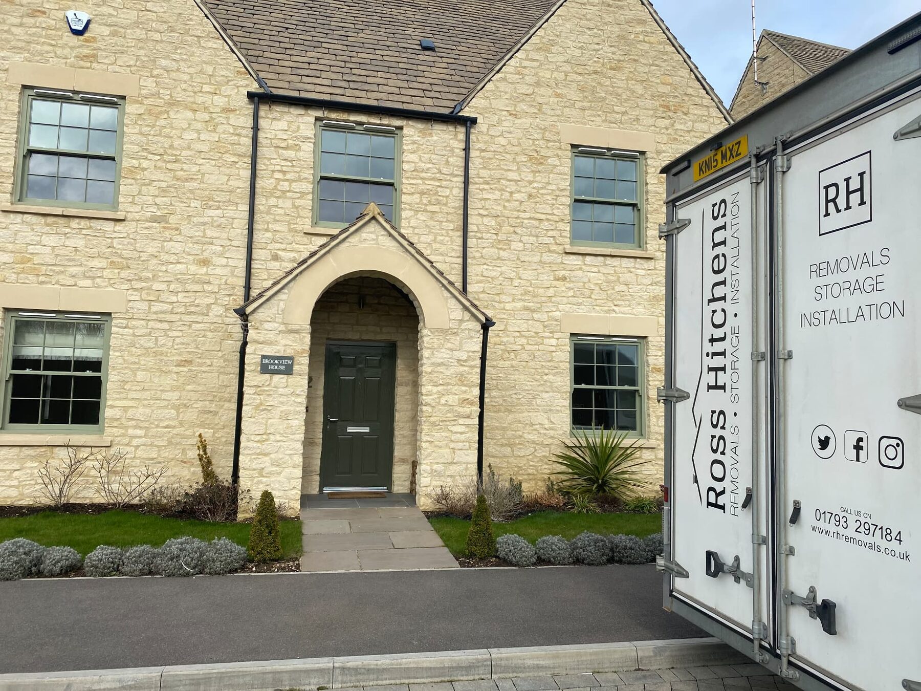RH removal van outside a Cotswold stone house