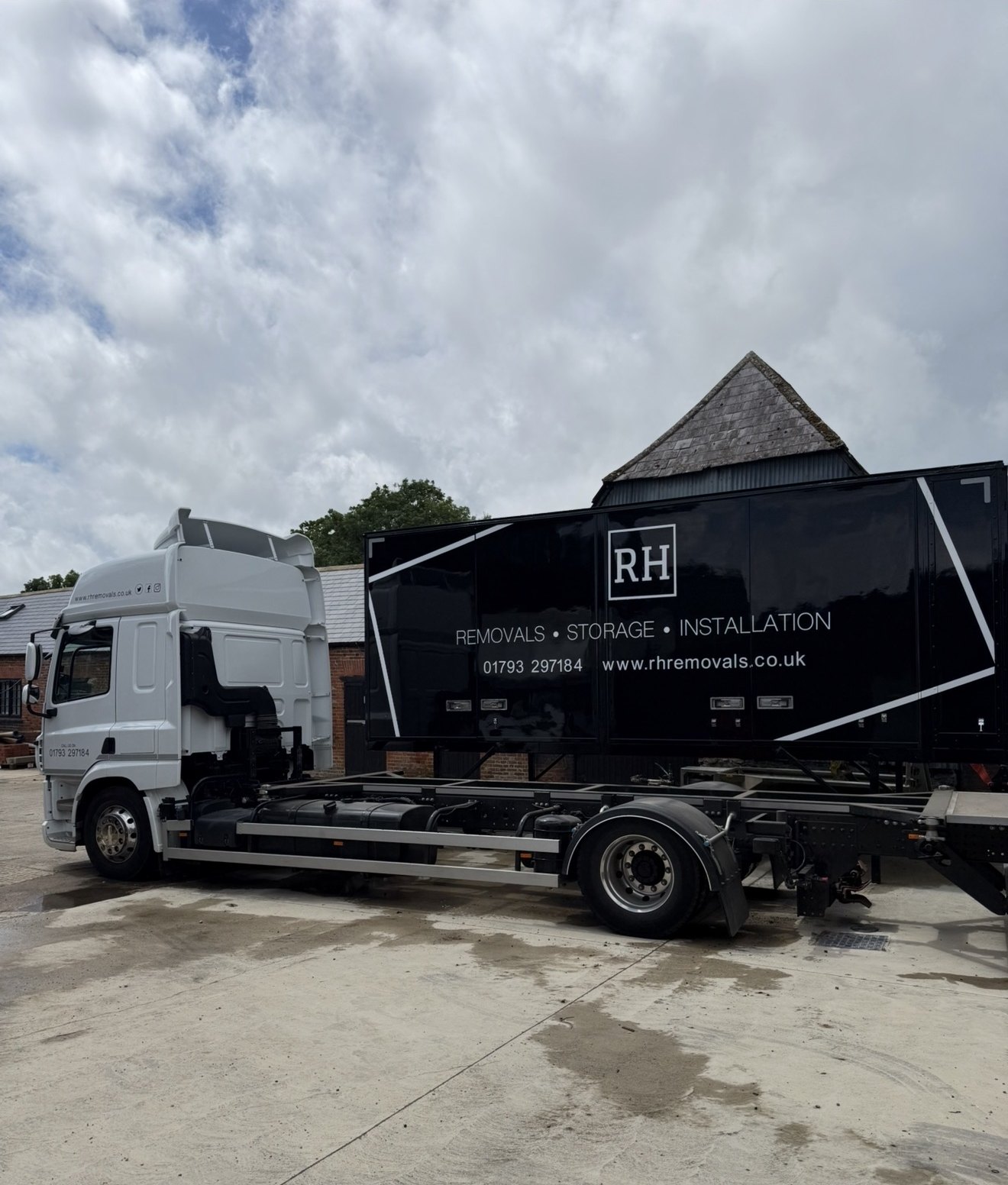 RH lorry chassis beside a black RH de-mount removal body standing on its legs