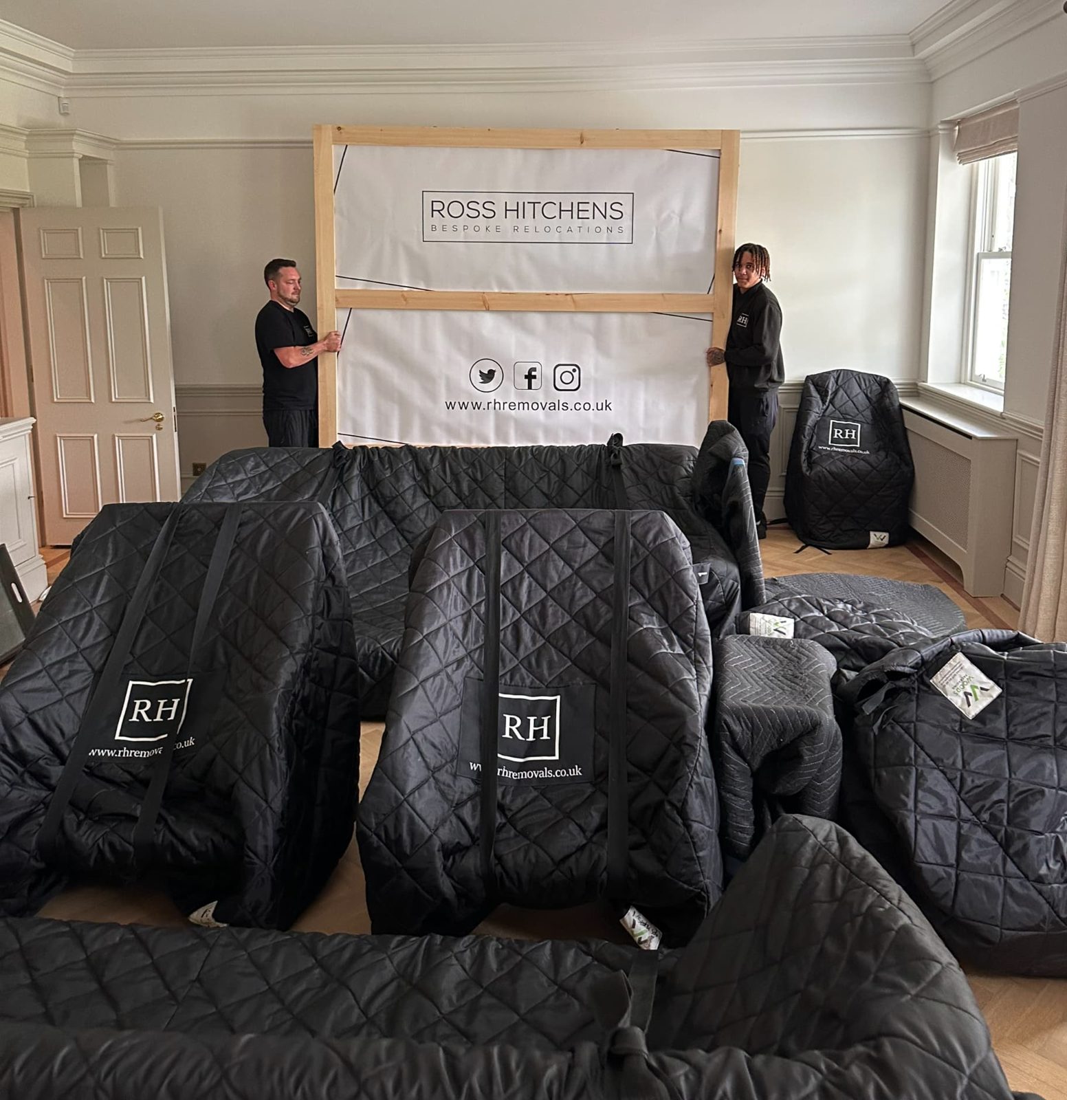 RH crew with furniture wrapped in RH-branded quilted covers